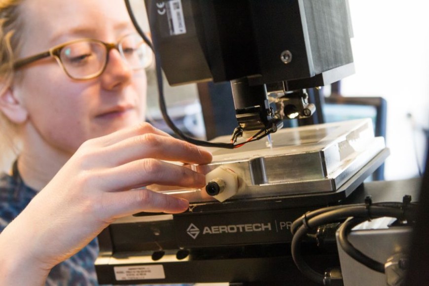A researcher working on a microscope. 