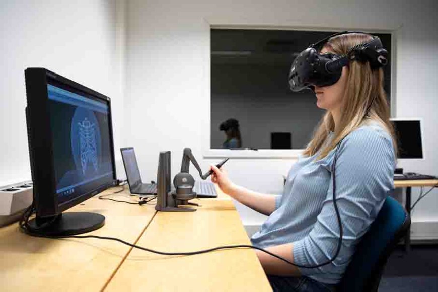Resercher is using a virtual headset at the computer.