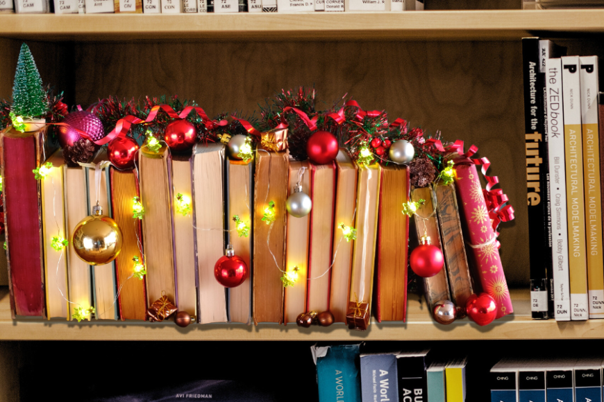 Kirjoja ja joulukoristeita kirjaston kirjahyllyssä.