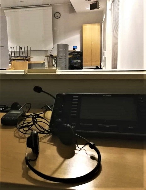 Simultaneous interpreting equipment inside the interpreter's booth, view of the interpreting studio from the booth window