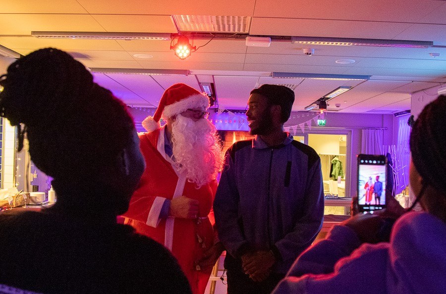 Santa Claus talking with a student.