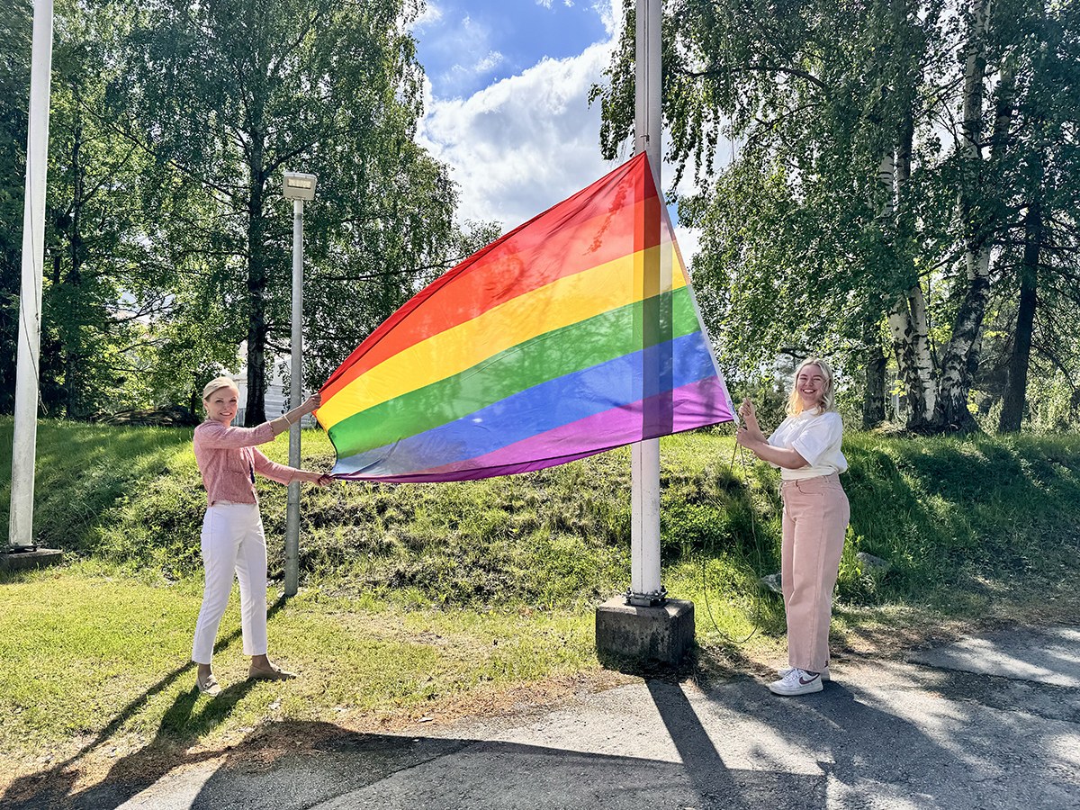 Katja Komulainen ja Julia Väänänen lifting the flag.