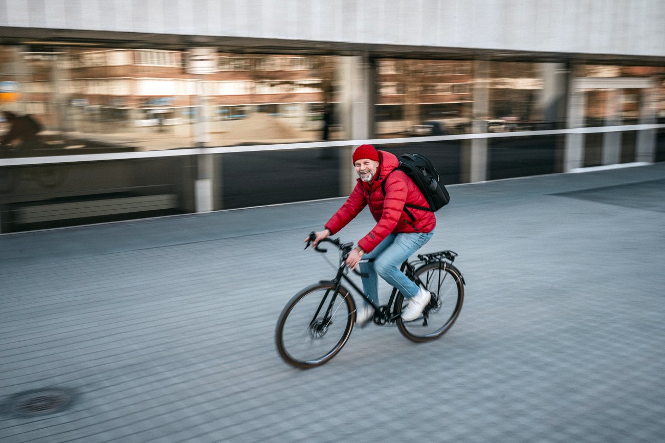 Pasi Toivonen ajaa polkupyörällä Tampereen yliopiston pihassa