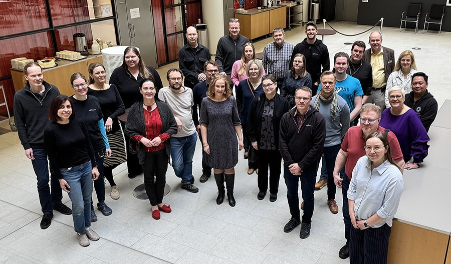 A group of people standing in a lobby.