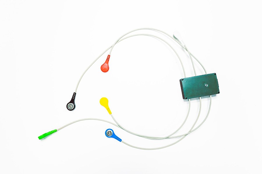 A small wearable monitoring device emitting colourful sensors.