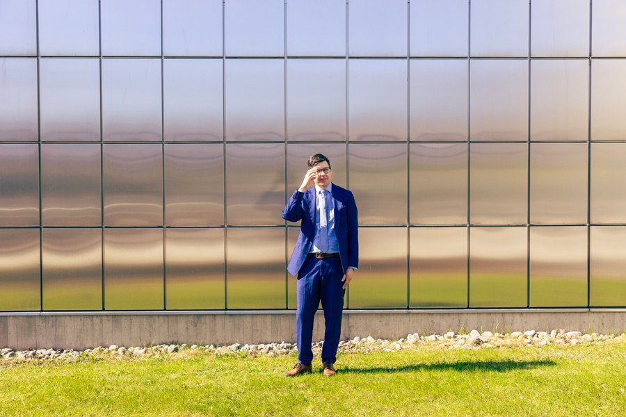Janne Ruohonen looks at the camera in front of a light metallic wall.