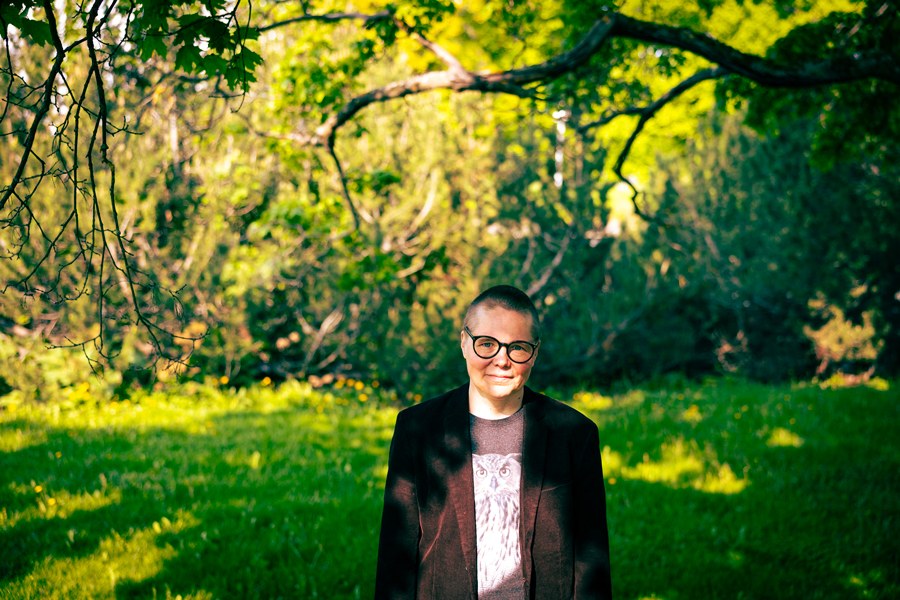 Joa Hiitola surrounded by trees.