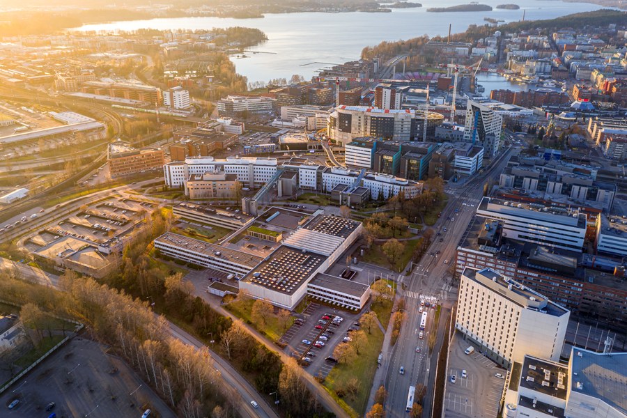 View of the city from the air. A lake glistens in the background.