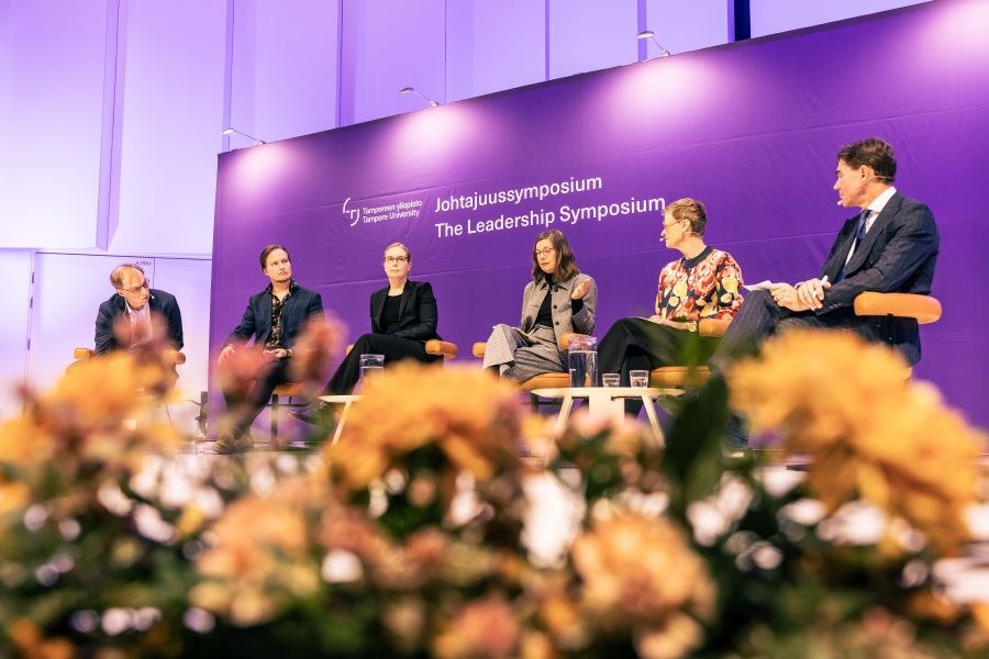 Panel discussion at the Leadership Symposium, with six participants contributing to the discussion.