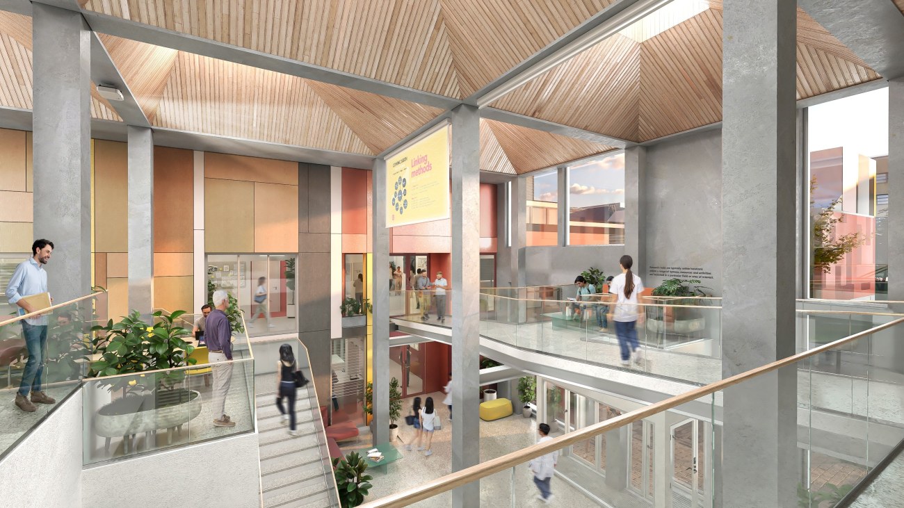 Tutkimuskeskus NOODIn sisätilat, jossa näkyy sisäänkäynti ja eri kerrosten välissä liikkuvia ihmisiä.