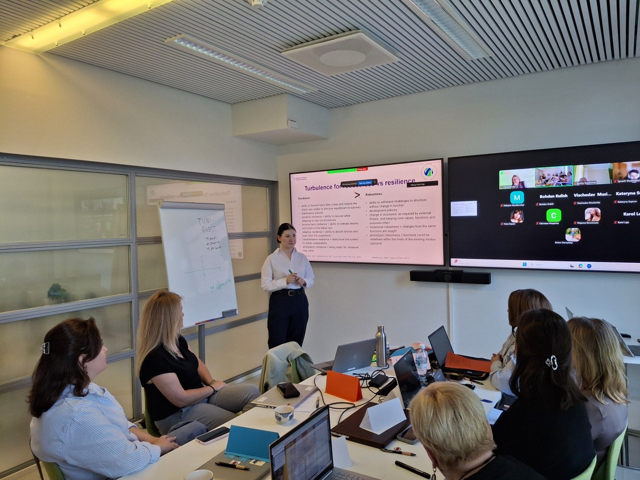 Lecturer delivering a talk to on-site and online students
