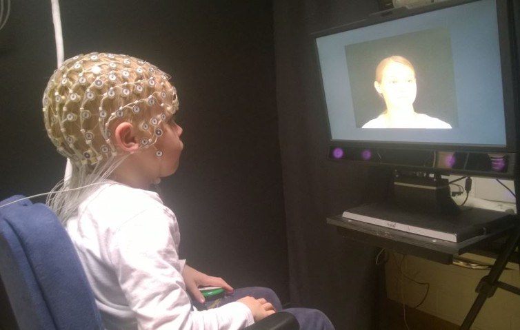 A child watching a video screen. 